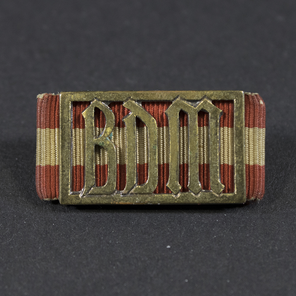 World War II German BDM Performance Badge displayed on a flat surface, showing its oval shape and detailed design.