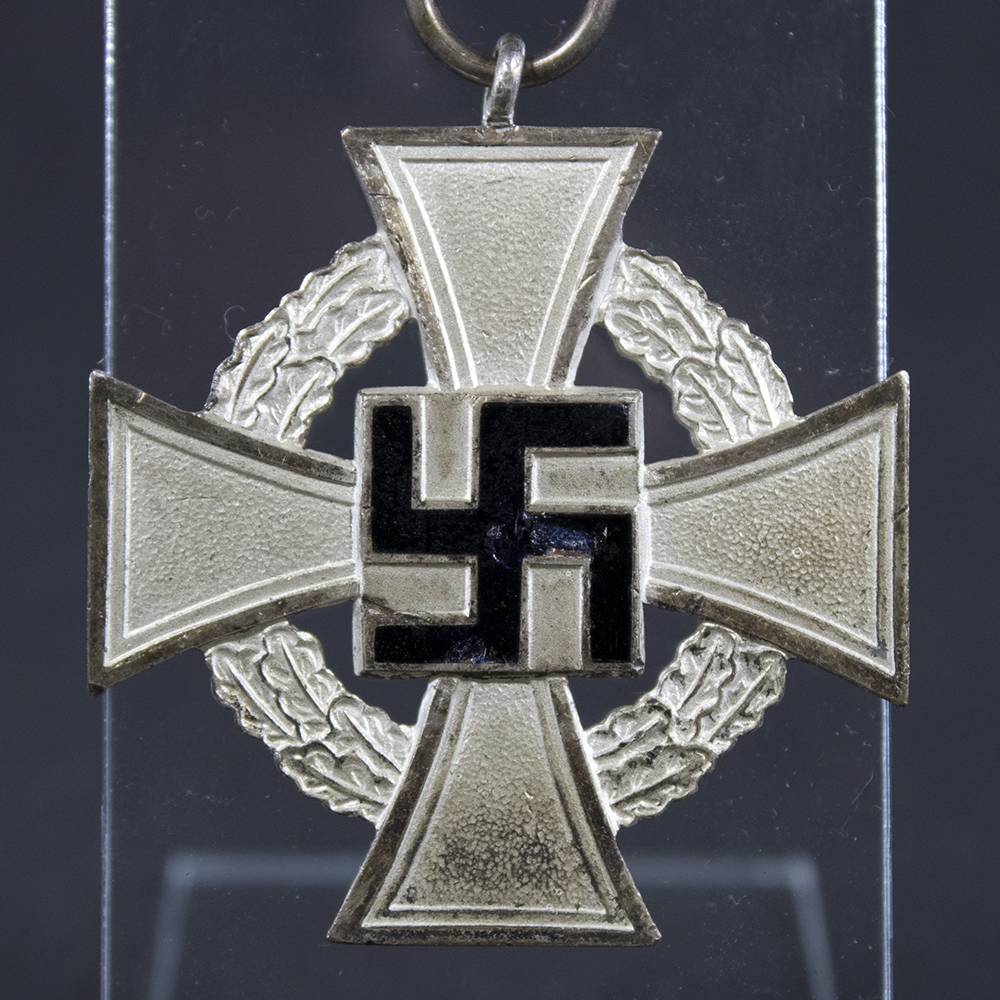 Close-up of the front of a WWII German 25 Years Faithful Service Medal, showing the central emblem and detailed enamel finish.