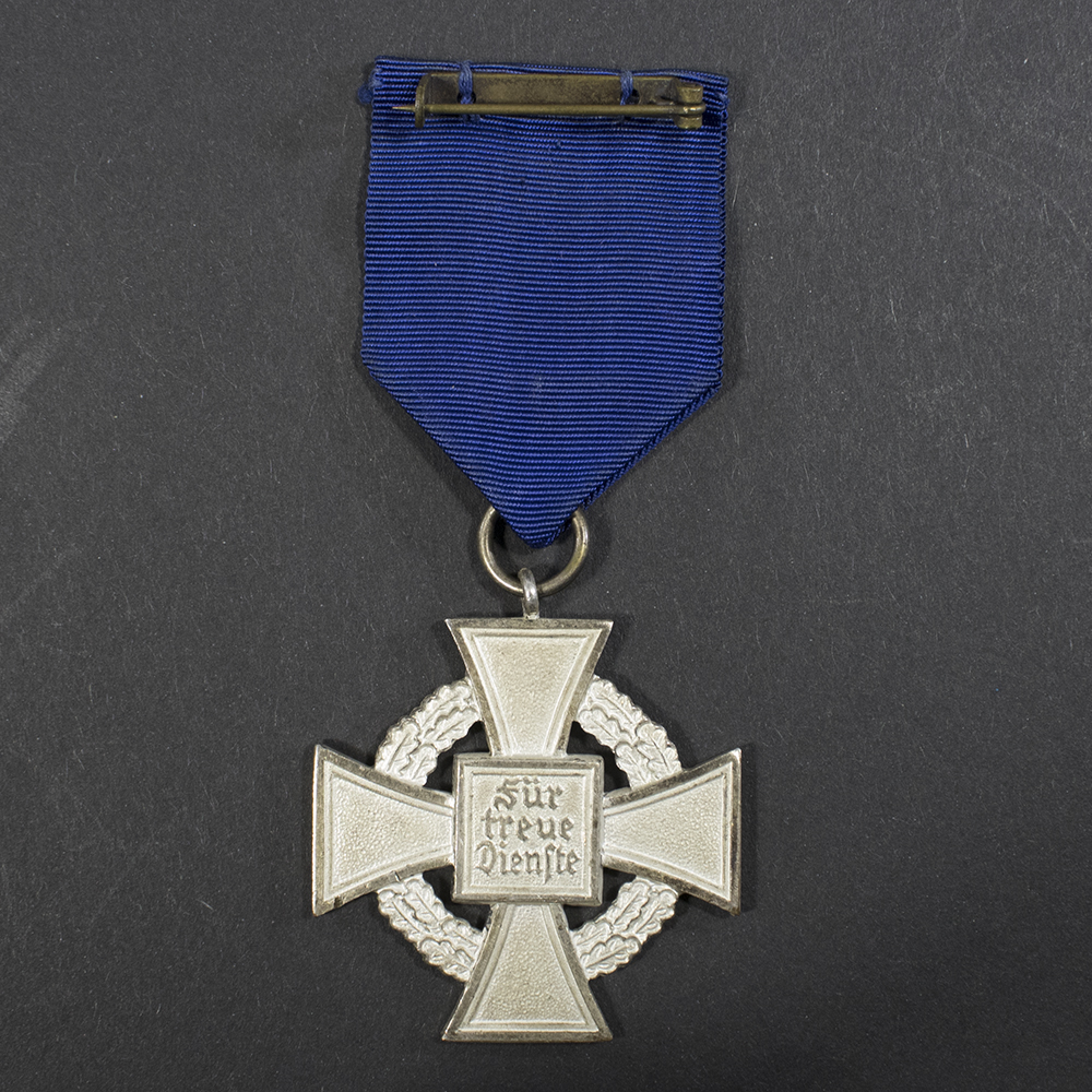 Overview of the reverse of a WWII German 25 Years Faithful Service Medal, showing the back of the cross and ribbon attachment.