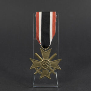 Overview of a WWII German War Merit Cross with Swords, cross-shaped medal with crossed swords mounted through the center.