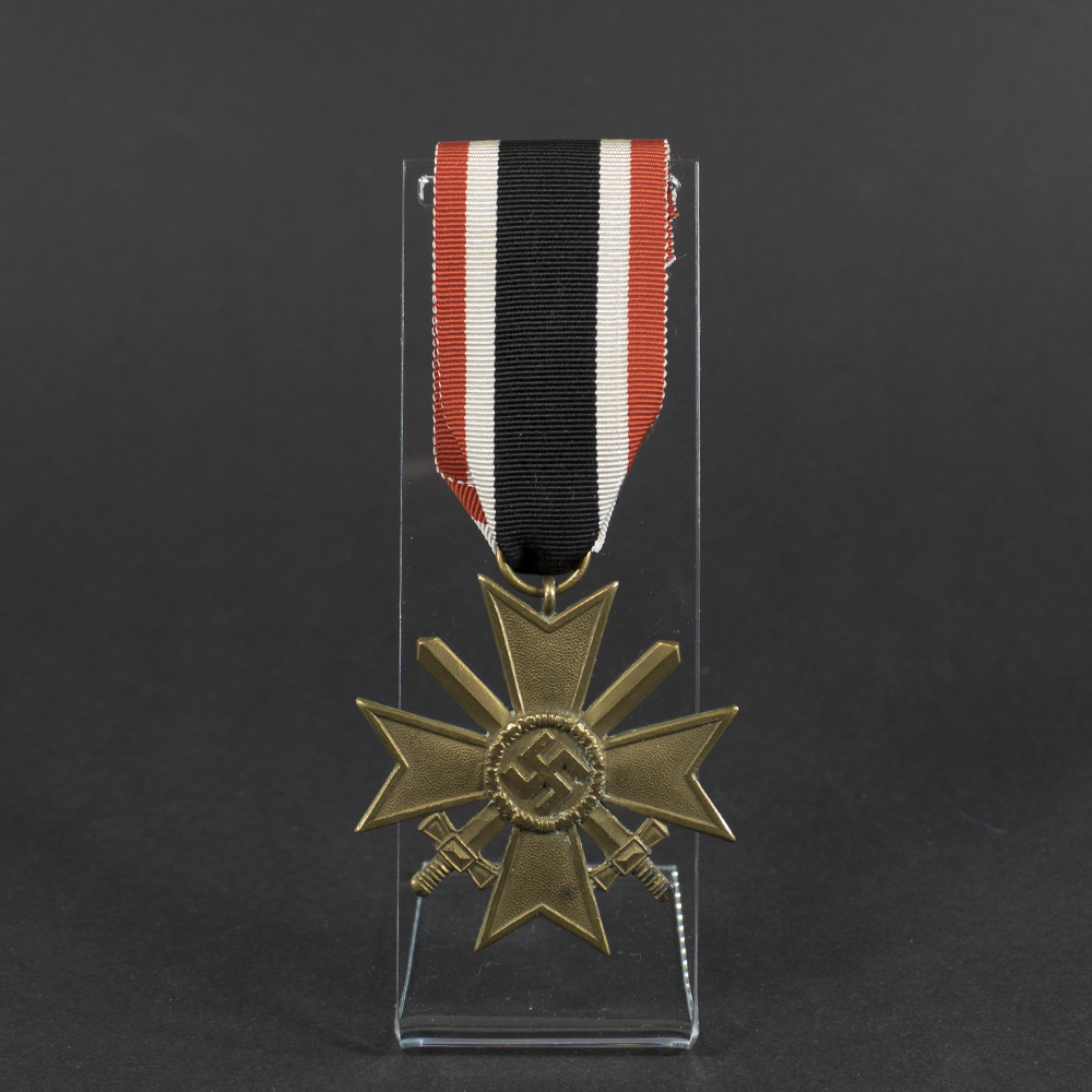 Overview of a WWII German War Merit Cross with Swords, cross-shaped medal with crossed swords mounted through the center.