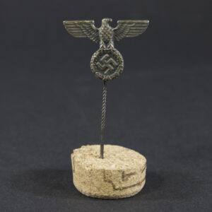 World War II German NSDAP breast eagle stick pin displayed on a flat surface, showing the full design and pin