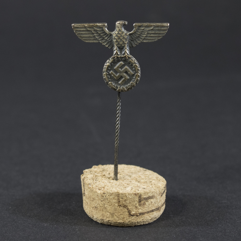 World War II German NSDAP breast eagle stick pin displayed on a flat surface, showing the full design and pin