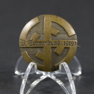 Front side of the Deutscher Turnerbund 1919 pin, showing the detailed emblem and inscription.