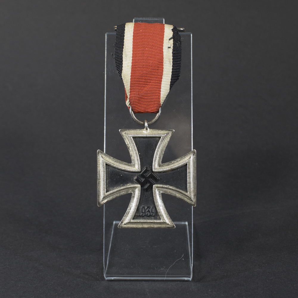 World War II German Iron Cross 2nd Class displayed with its ribbon, showing the front design with black core and silver frame.