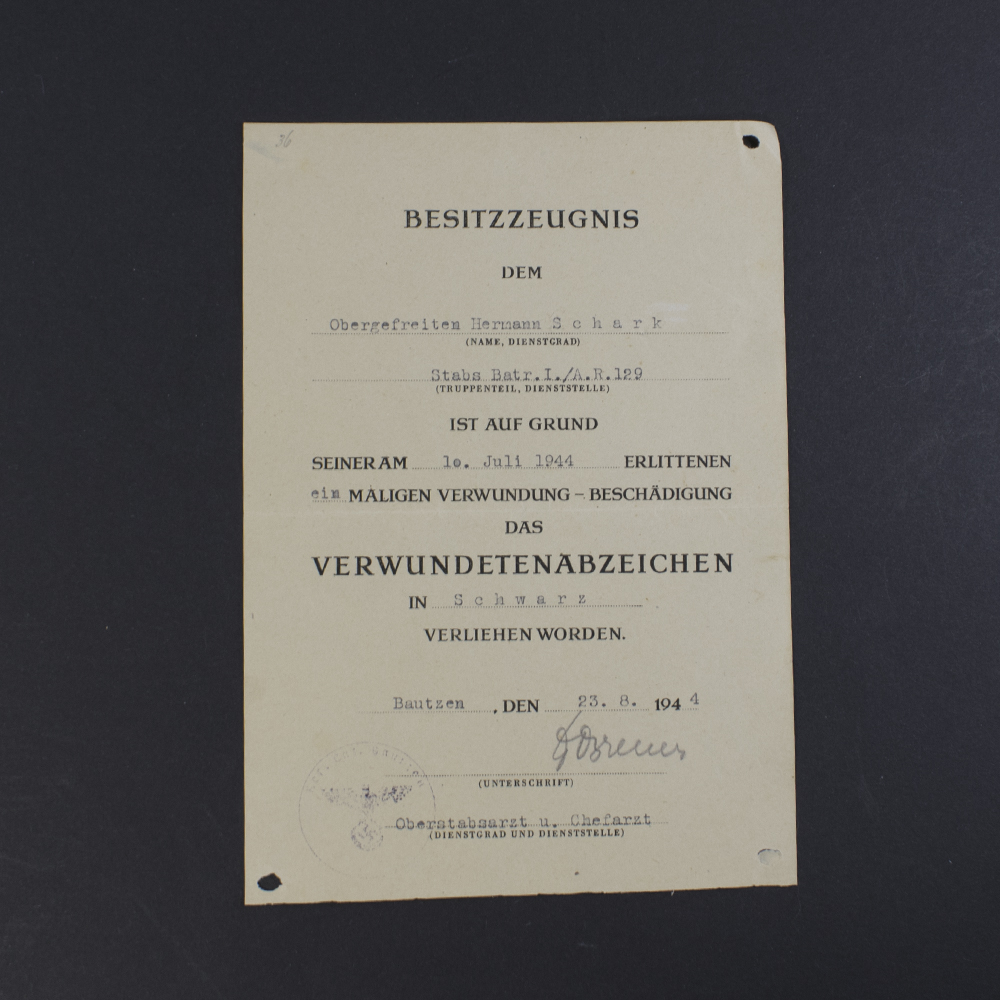 Front side of the World War II German Black Wound Badge award document, showing printed text, handwritten details, and official stamps.