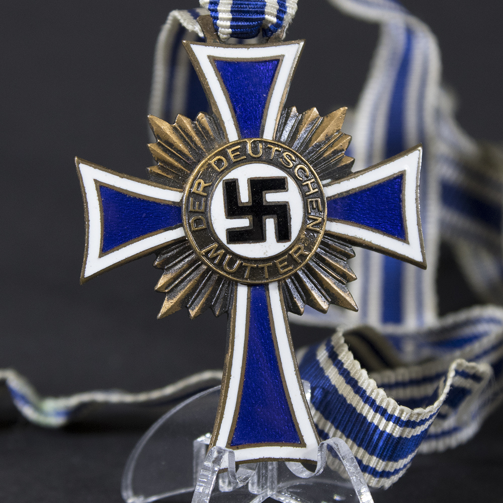 Front side of the bronze Mother’s Cross, showing the enamel finish, central swastika emblem, and inscription.