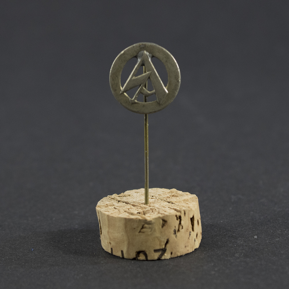 Overview of a WWII German SA membership stick pin, showing the small enamel pin attached to a metal post.