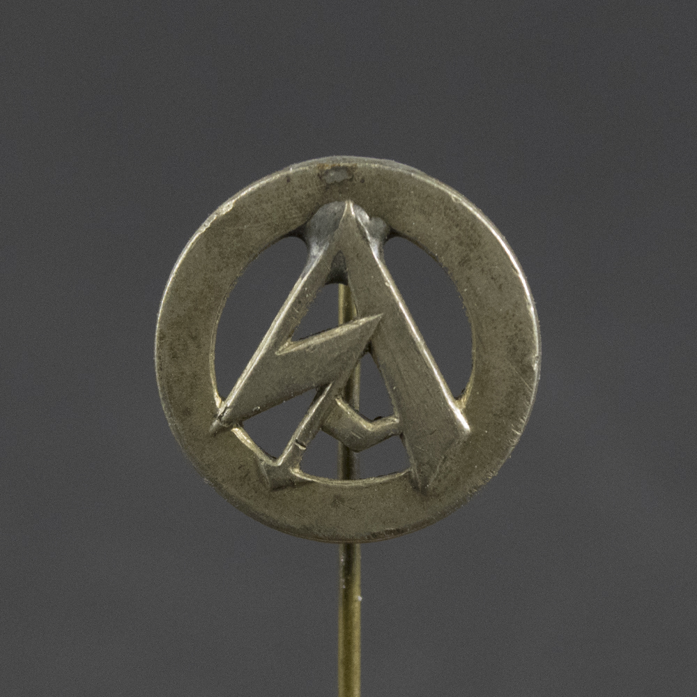 Close-up of the front of a WWII German SA membership stick pin, showing the detailed enamel design and emblem.