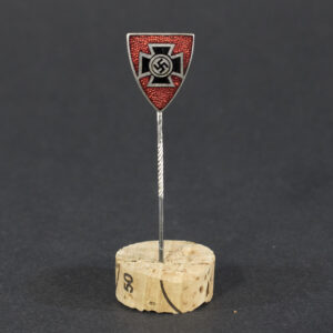 World War II German Kyffhäuserbund membership stick pin displayed flat, showing the small circular badge with detailed emblem attached to a slender pin.