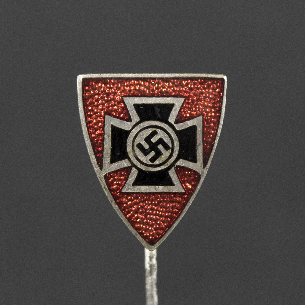 Front side of the WWII German Kyffhäuserbund membership stick pin, featuring the intricate design with central tower motif and surrounding text on a silver-toned background.