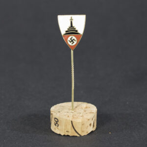 World War II German Kyffhäuserbund membership stick pin displayed flat, showing the small circular badge with detailed emblem attached to a slender pin.