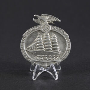 Overview of a German “Seefahrt ist Not” commemorative tinnie, showing the small metal badge.