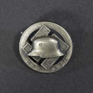 WWII German N.S.D.F.B.St membership pin displayed flat, showing its oval badge with detailed emblem and attached stick pin.