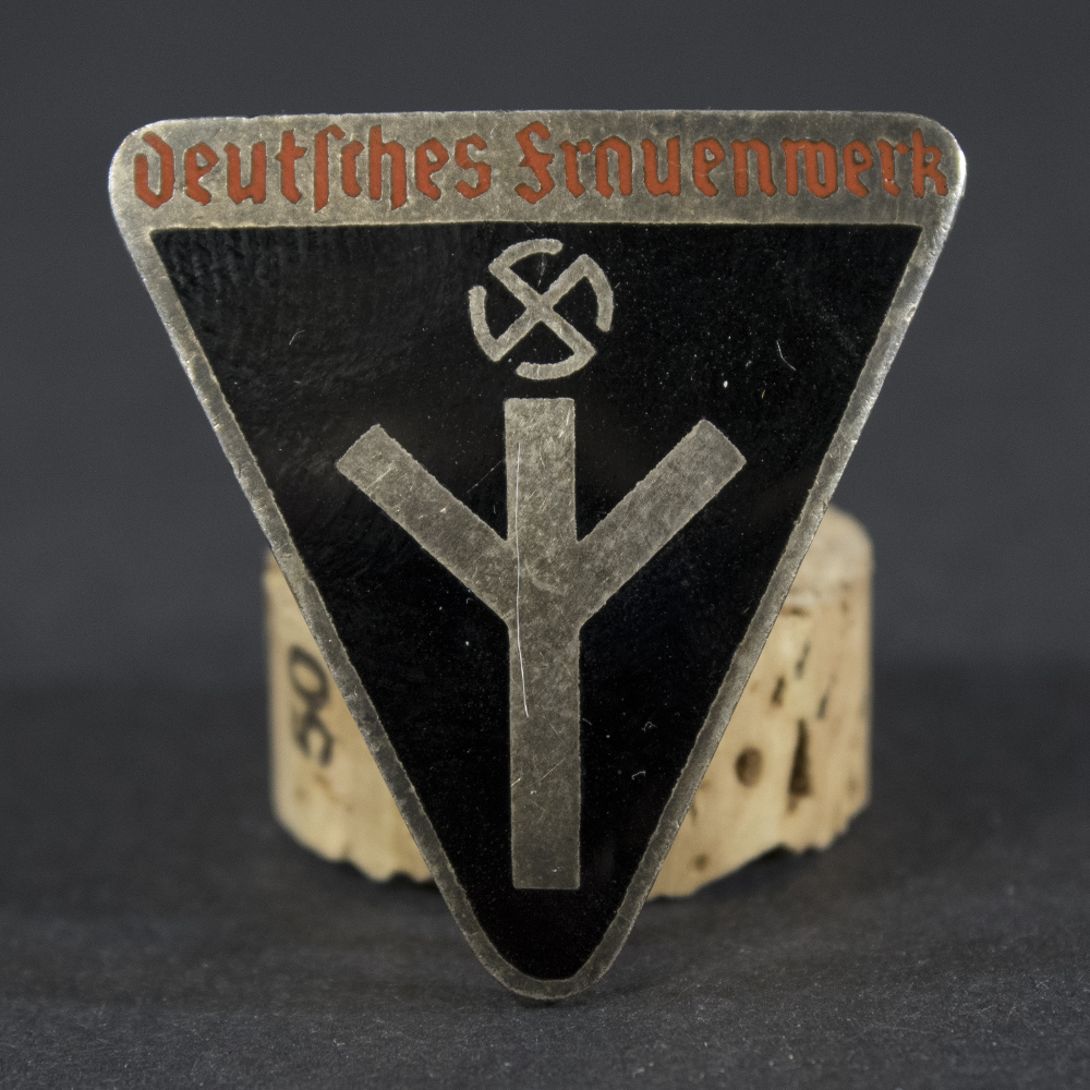 Front side of the WWII German Deutsches Frauenwerk badge, featuring the intricate design with raised lettering and enamel finish.