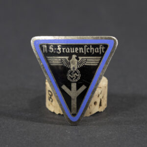 WWII German NS Frauenschaft Ortsgruppe staff badge displayed flat, showing its oval shape with detailed emblem and attached pin.