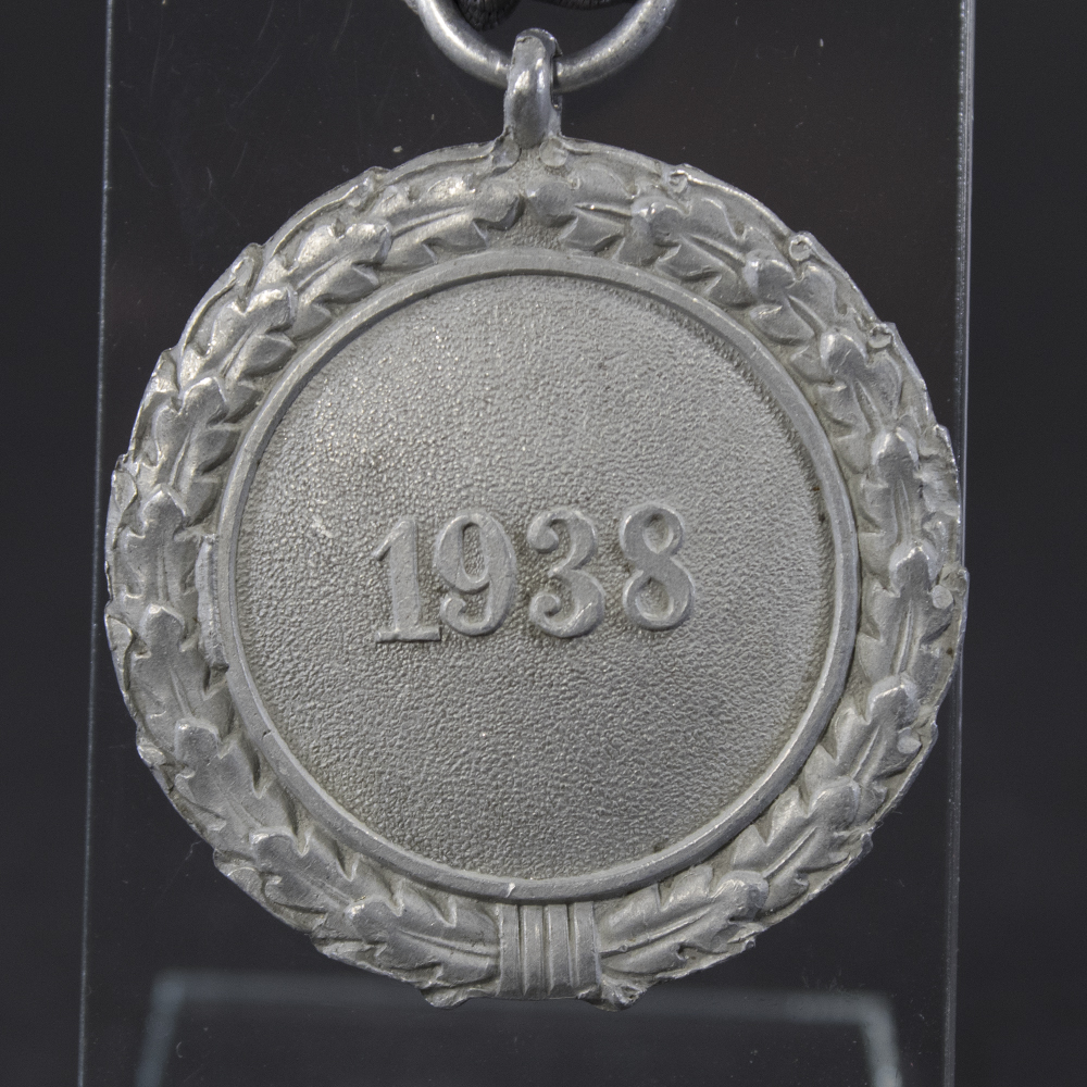 Close-up of the Luftschutz medal’s front and back, highlighting fine details of the emblem, lettering, and metal texture.