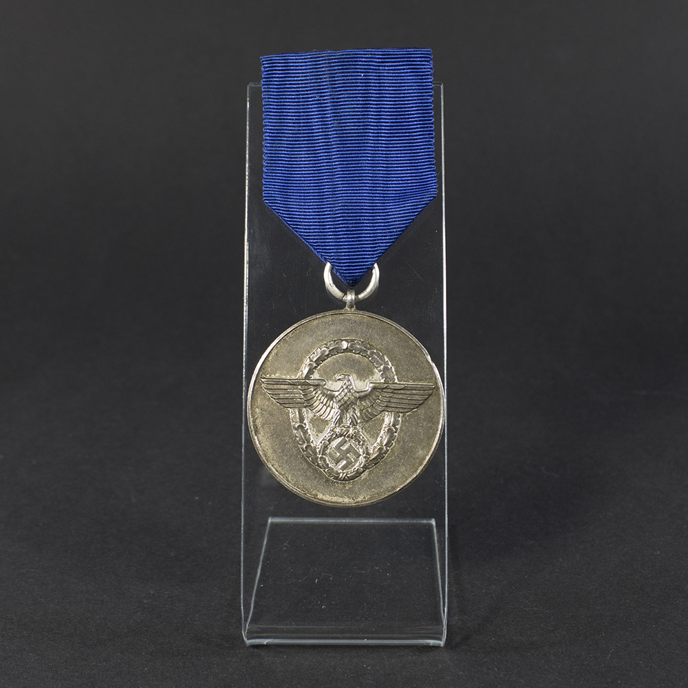 WWII German 8-Year Police Long Service Medal displayed flat, showing the front side with detailed embossed police eagle emblem and attached suspension ring.
