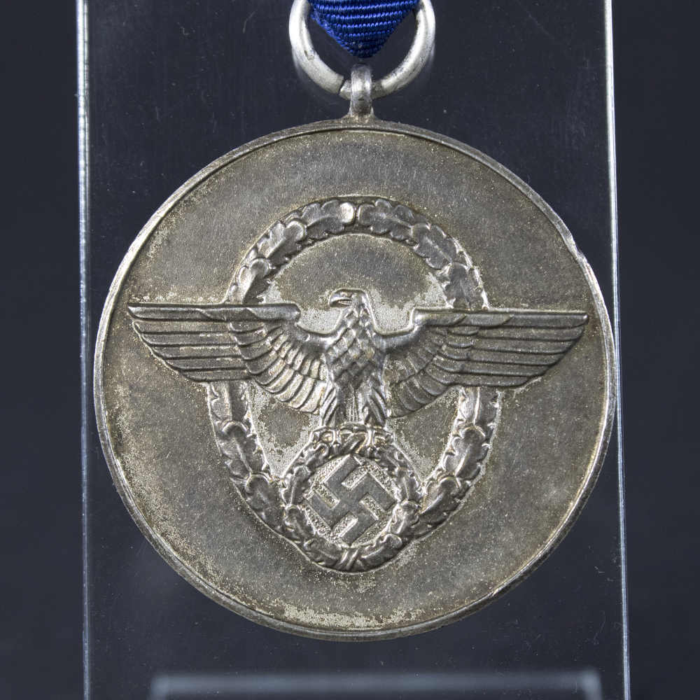 Close-up of the front side of the WWII German 8-Year Police Long Service Medal, highlighting the eagle design, wreath details, and silver finish.