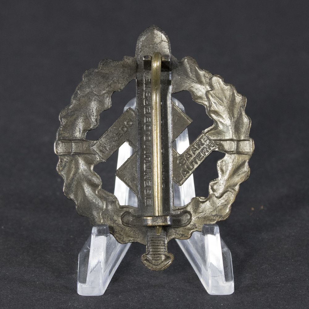 Back side of the WWII German Bronze SA Sports Badge, displaying the smooth reverse surface with pin attachment mechanism.