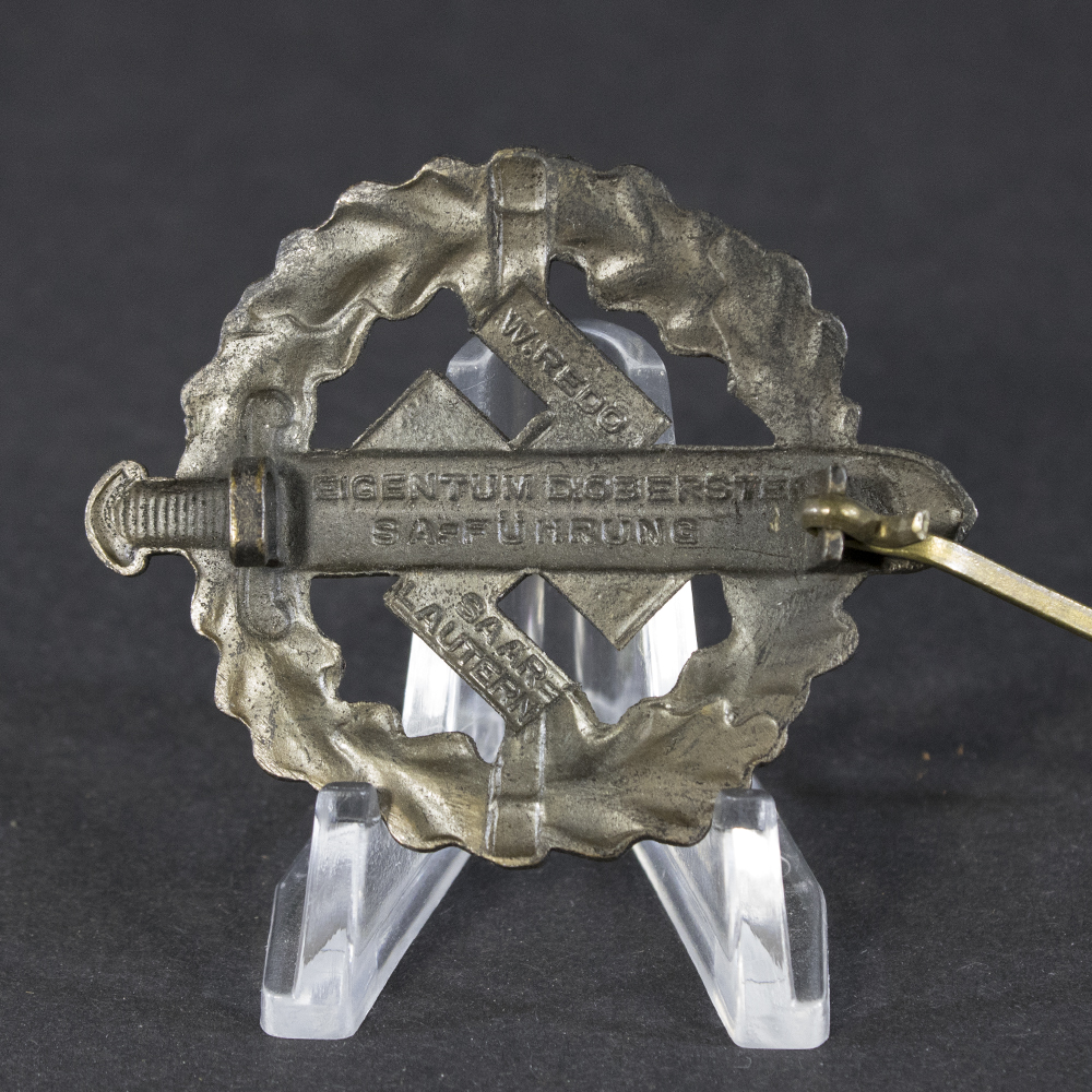 Close-up of the back side of the WWII German Bronze SA Sports Badge, highlighting the maker’s marks and stamped details near the pin.