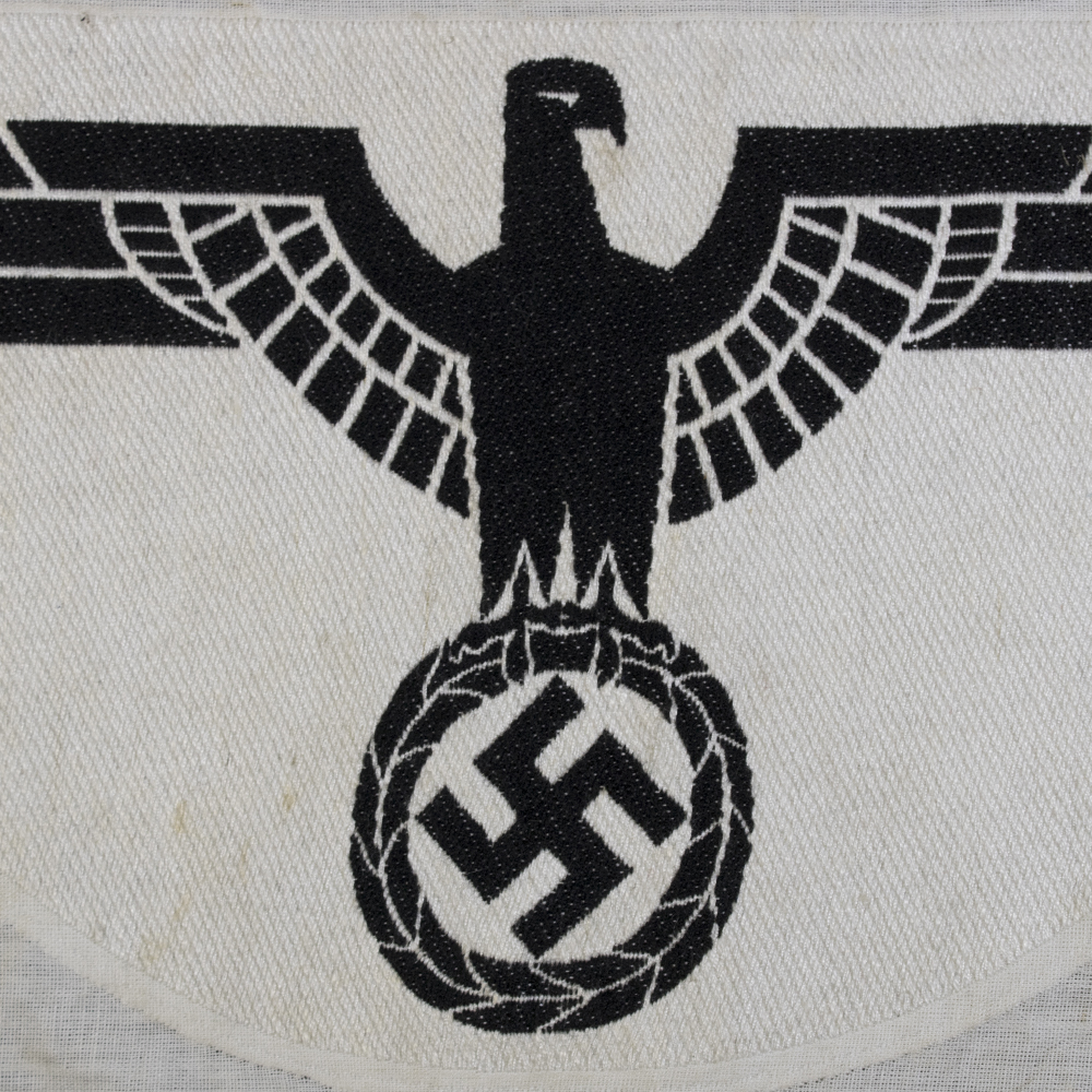 Close-up of the front of a 1st pattern WWII Heer Sports Breast Eagle cloth badge, highlighting detailed embroidery and stitching.