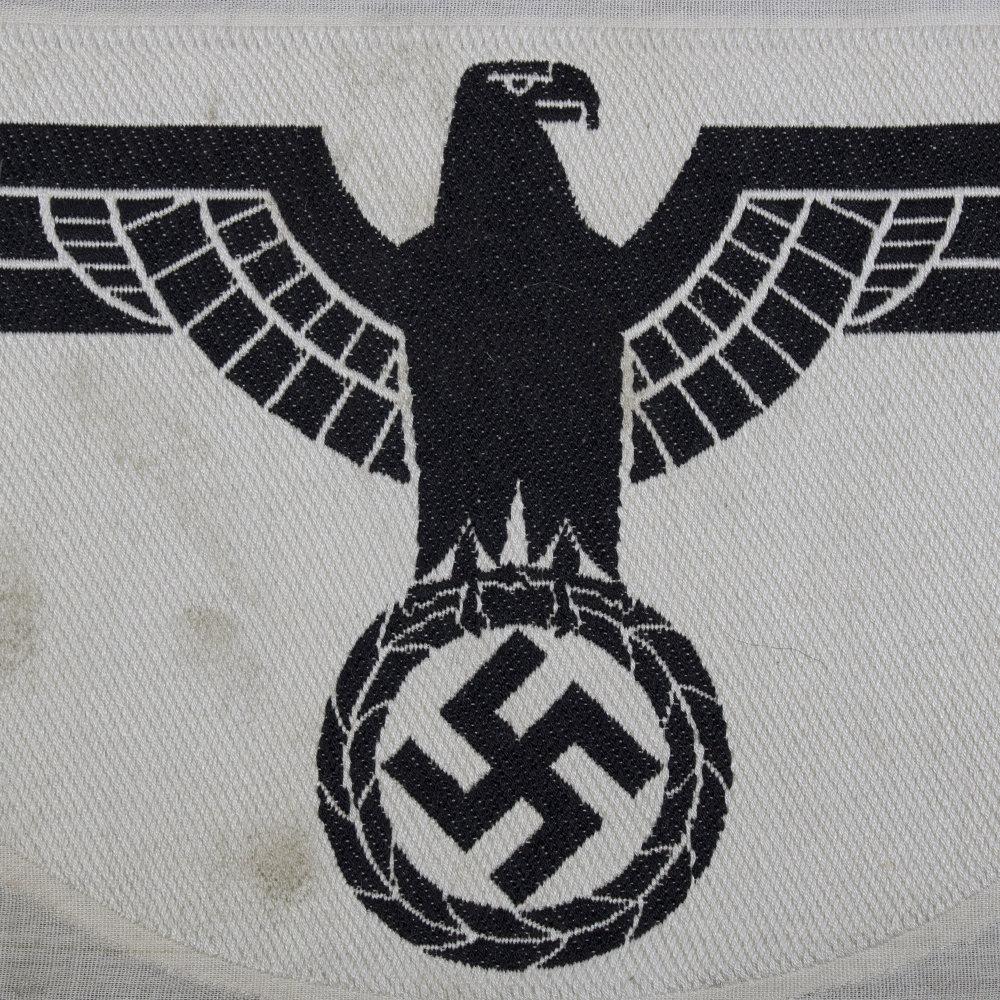 Close-up of the front of a 1st pattern WWII Heer Sports Breast Eagle cloth badge, highlighting detailed embroidery and stitching.