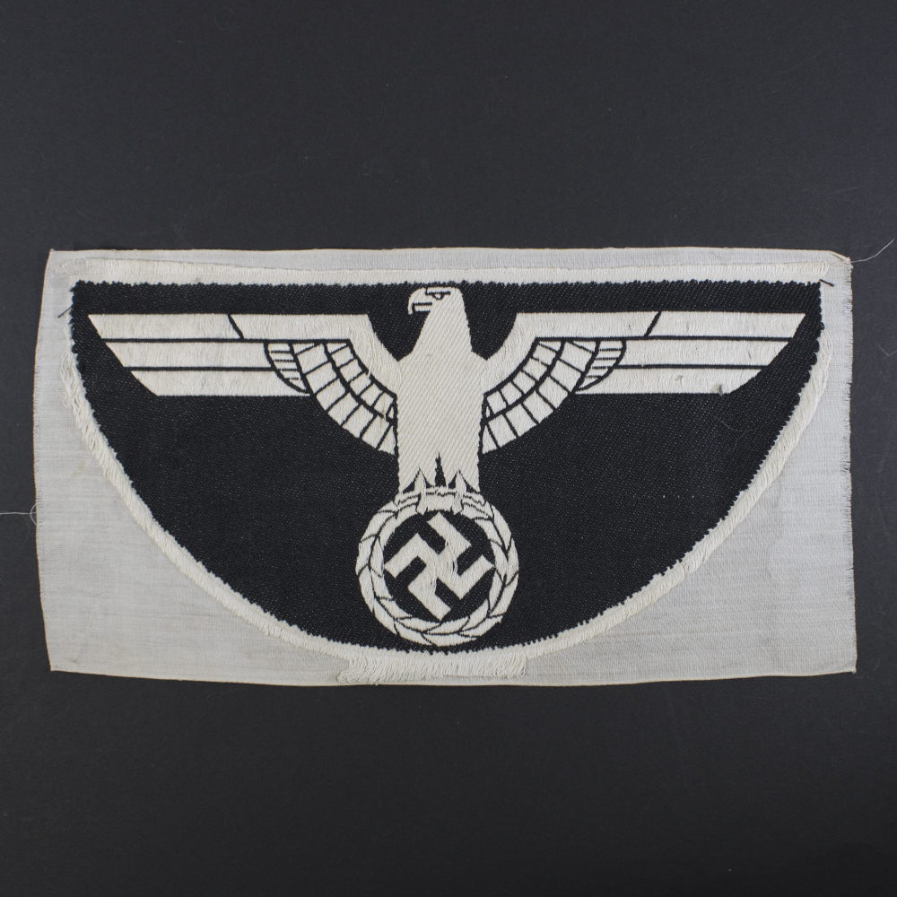 Overview of the reverse of a 1st pattern WWII Heer Sports Breast Eagle cloth badge, showing the full backing and stitch construction.