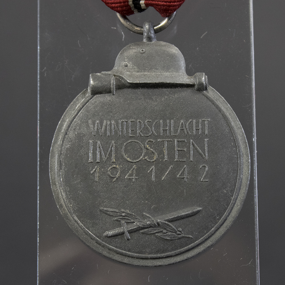 Close-up of the reverse of a WWII Eastern Front Medal, showing the inscription.