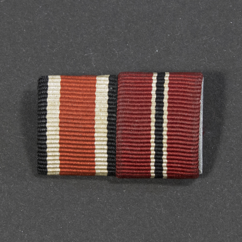 Close-up of the front of a WWII ribbon bar, showing ribbons for the Iron Cross 2nd Class and Eastern Front Medal.