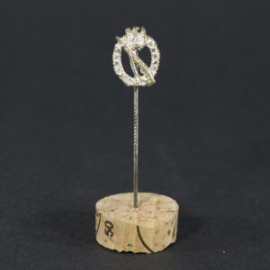 World War II German Silver Infantry Assault Badge stick pin displayed flat, showing the miniature badge with detailed wreath and rifle design attached to a slender pin