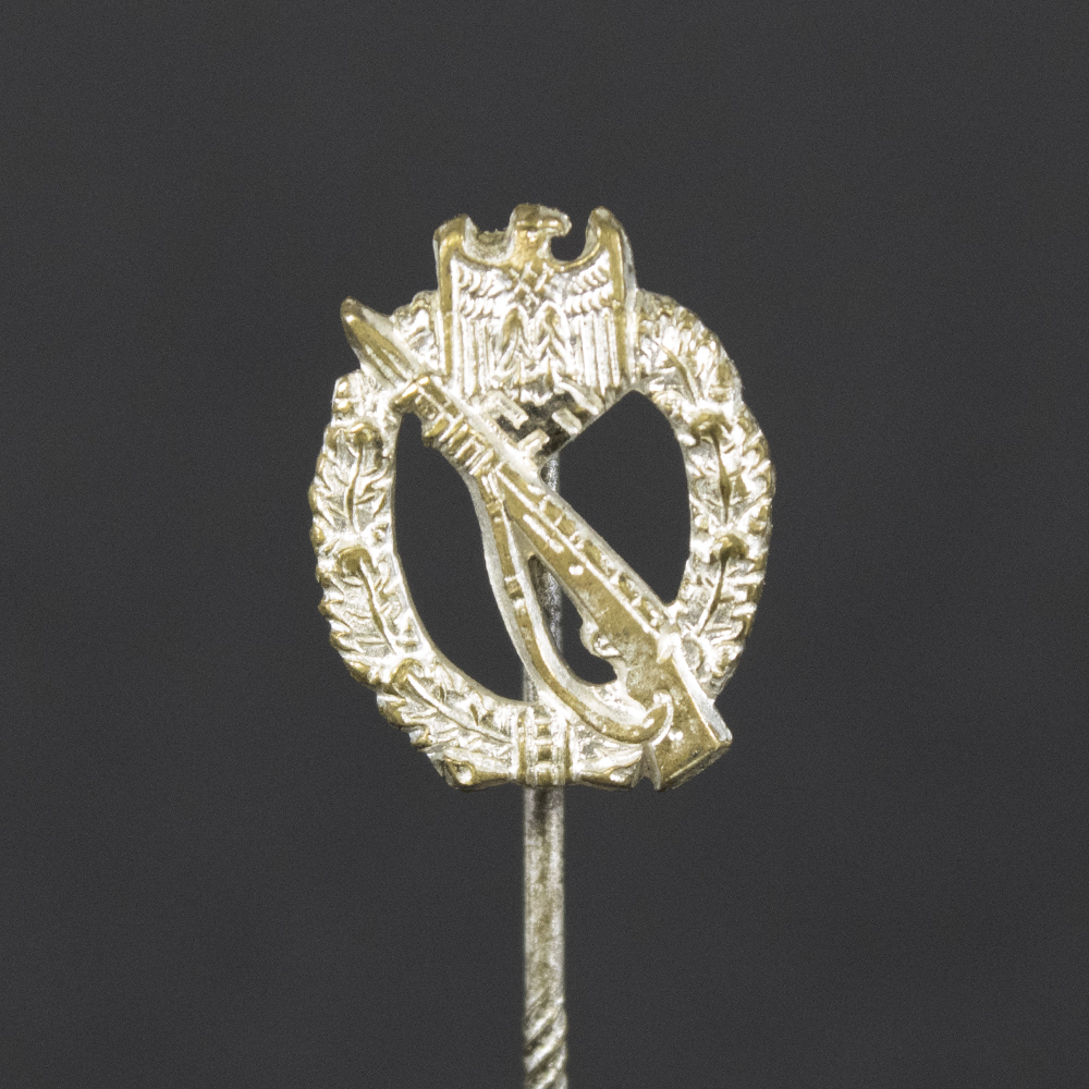 Front side of the WWII German Silver Infantry Assault Badge stick pin, featuring the intricate silver finish with oak leaf wreath and crossed rifle motif.
