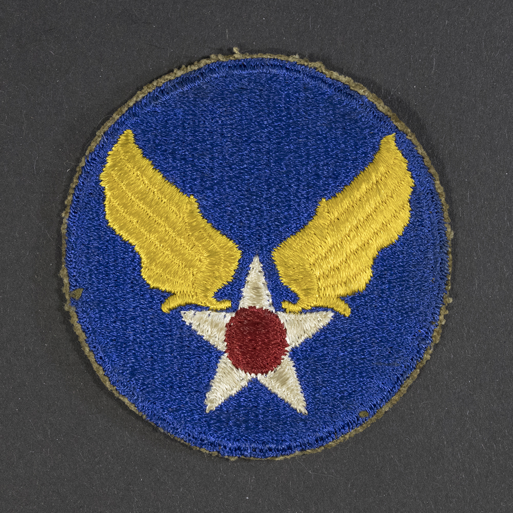Front of WWII U.S. Army Air Forces patch with green backing, showing emblem and shield shape in good condition.