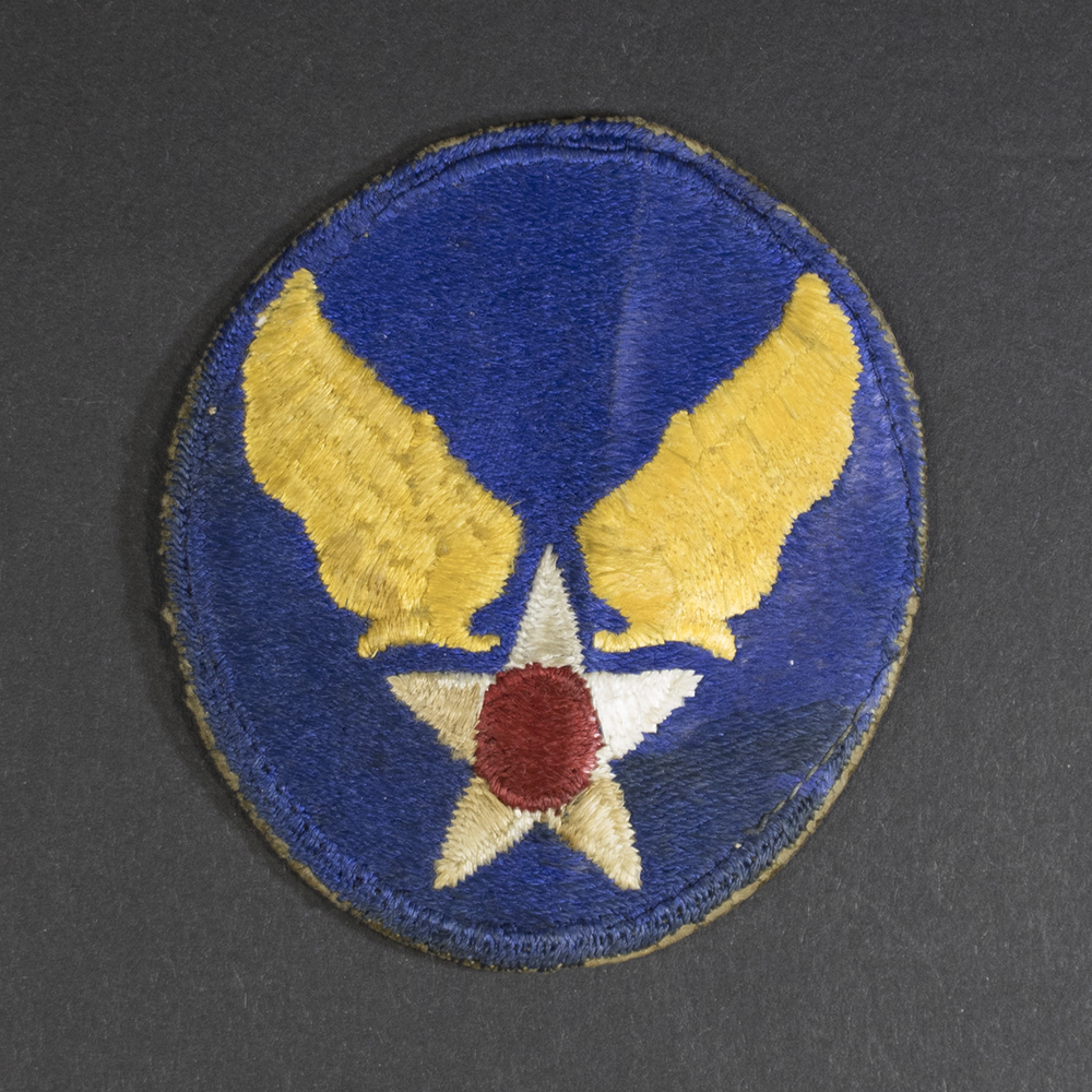 Front of WWII U.S. Army Air Forces patch with green backing, showing emblem and shield shape in good condition.