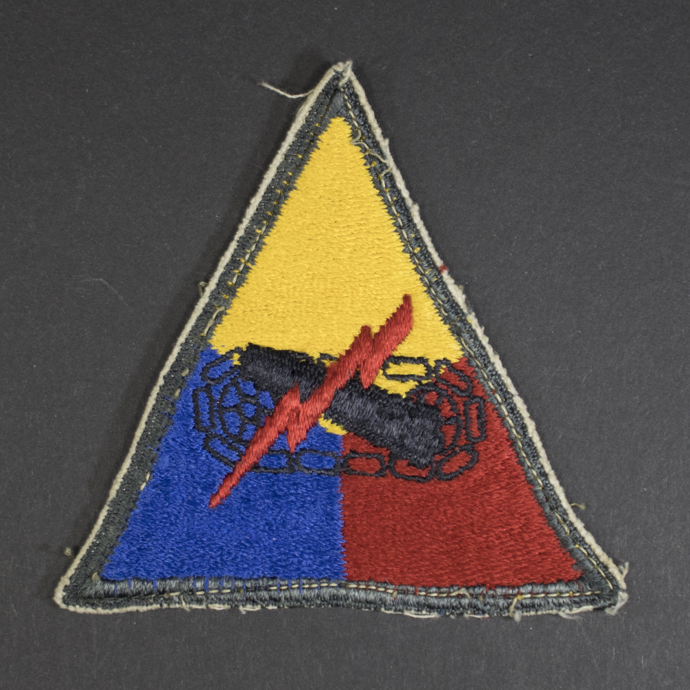 Front of WWII U.S. Army Armored Forces patch, featuring tank emblem on shield shape in good condition.