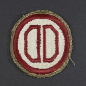 Front of WWII U.S. Army 31st Infantry Division patch with green backing, showing red circle on olive background in good condition.