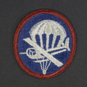 Front of WWII U.S. Army enlisted men’s combined glider and parachute cap patch, showing winged parachute and glider emblem in good condition.