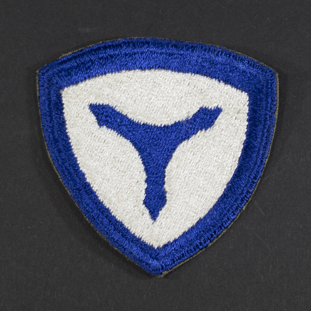 Front of WWII U.S. Army 3rd Service Command patch, featuring blue circle with white star and red center, surrounded by a yellow border.