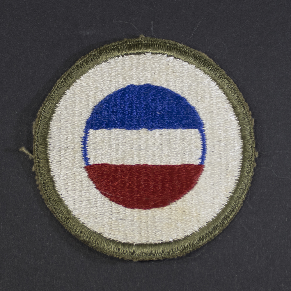 Front of WWII U.S. Army General Headquarters Reserve patch, featuring blue shield with white star and red center in good condition