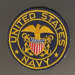 Front of WWII United States Navy patch, featuring blue background with gold anchor and rope design in good condition.