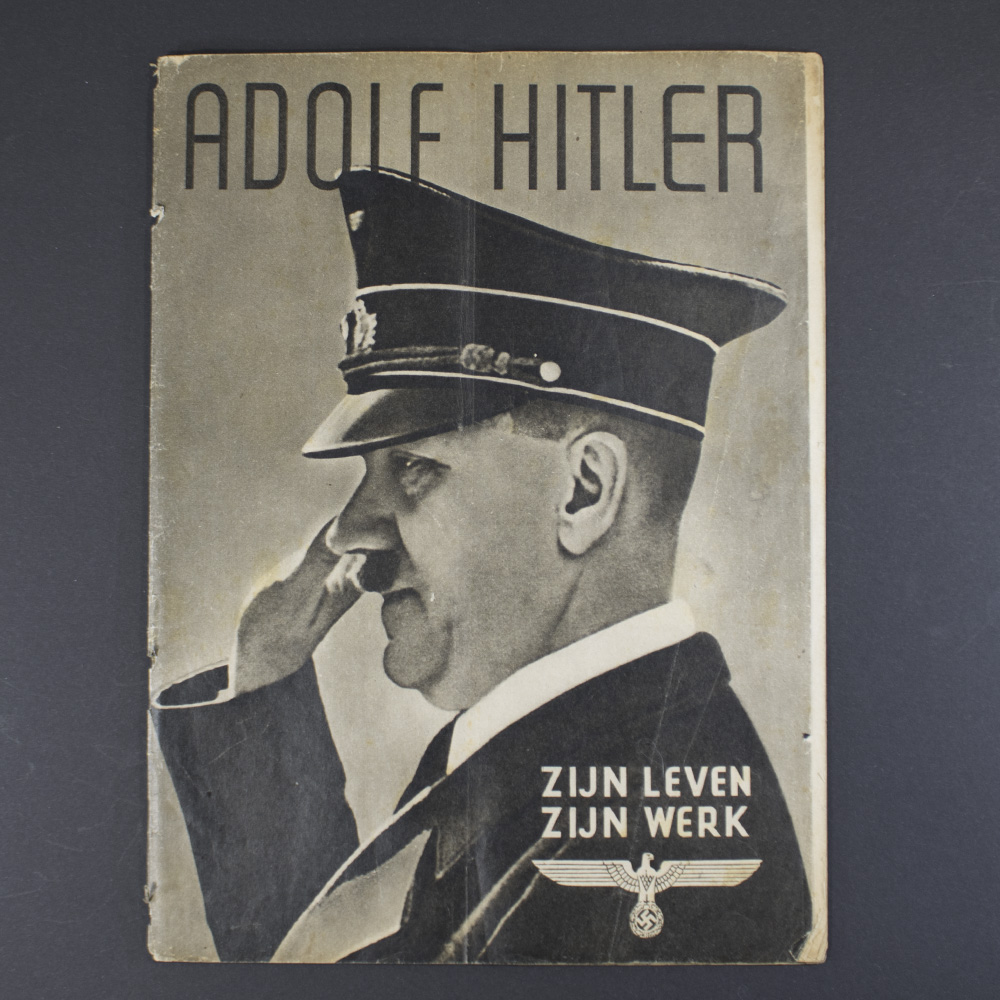 Front cover of the historical Dutch World War II magazine Adolf Hitler – Zijn leven Zijn werk, showing period‑style layout and imagery used for propaganda