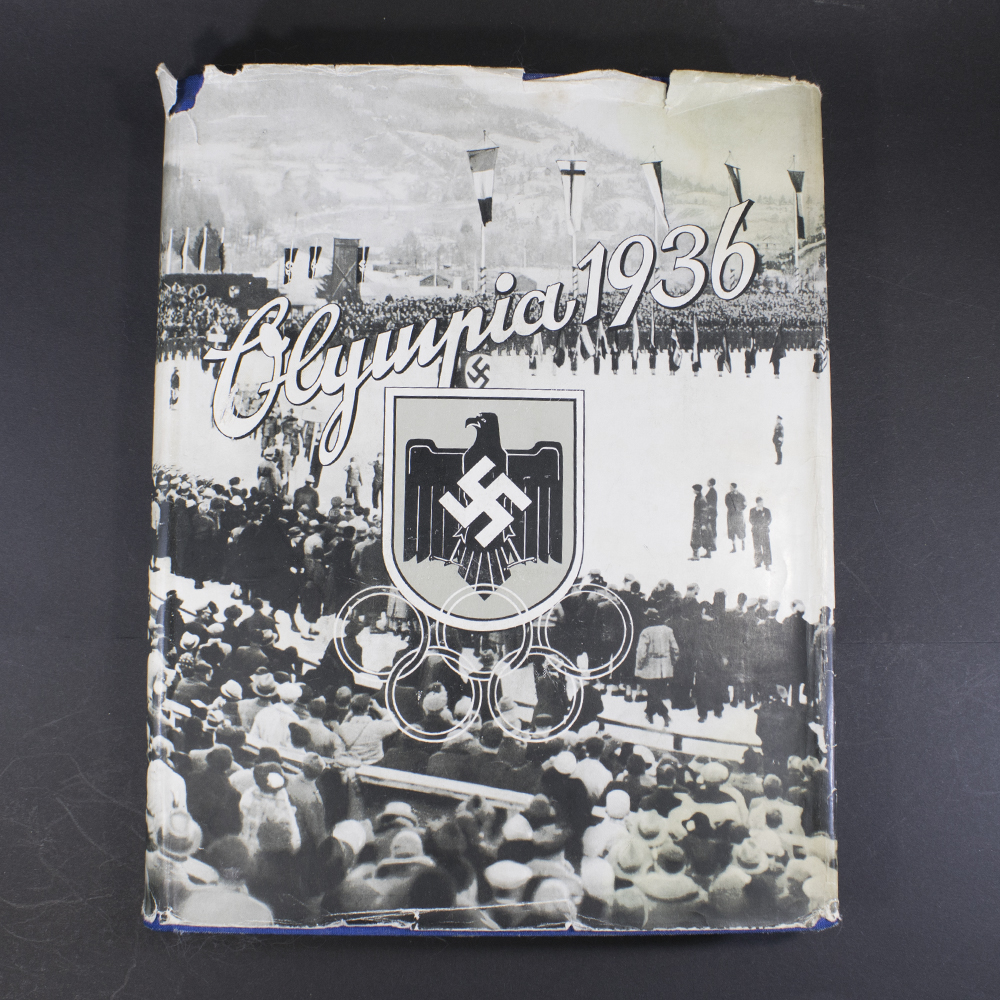 Front cover of the Olympia 1936 Winter Games cigarette album, featuring period artwork related to the 1936 Winter Olympics.