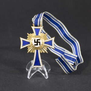 Overview photo of a World War II German Mother’s Cross in Gold, showing the full medal with ribbon and its period design.