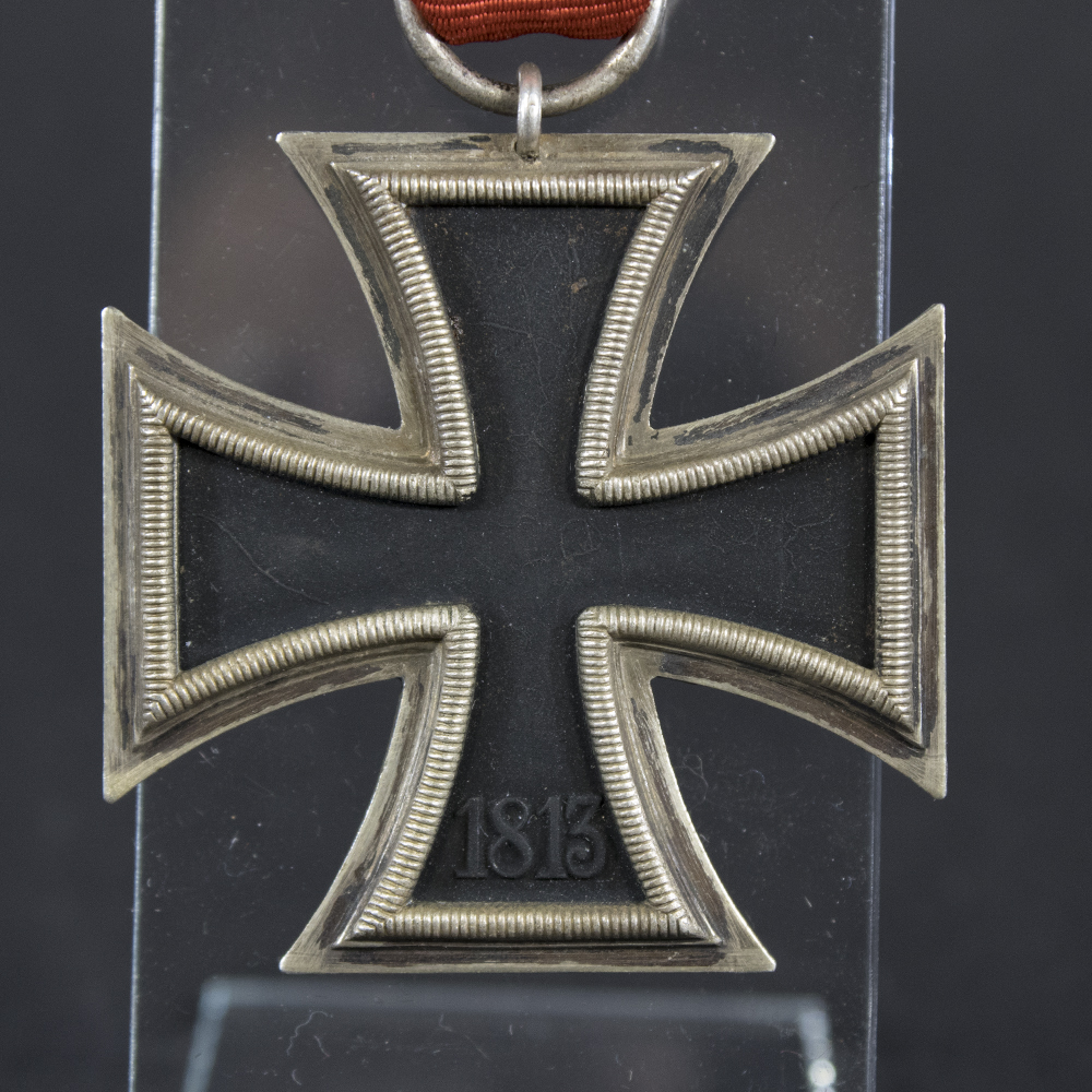 Close‑up of the reverse side of the Iron Cross 2nd Class, displaying the 1813 date and the textured metal surface.