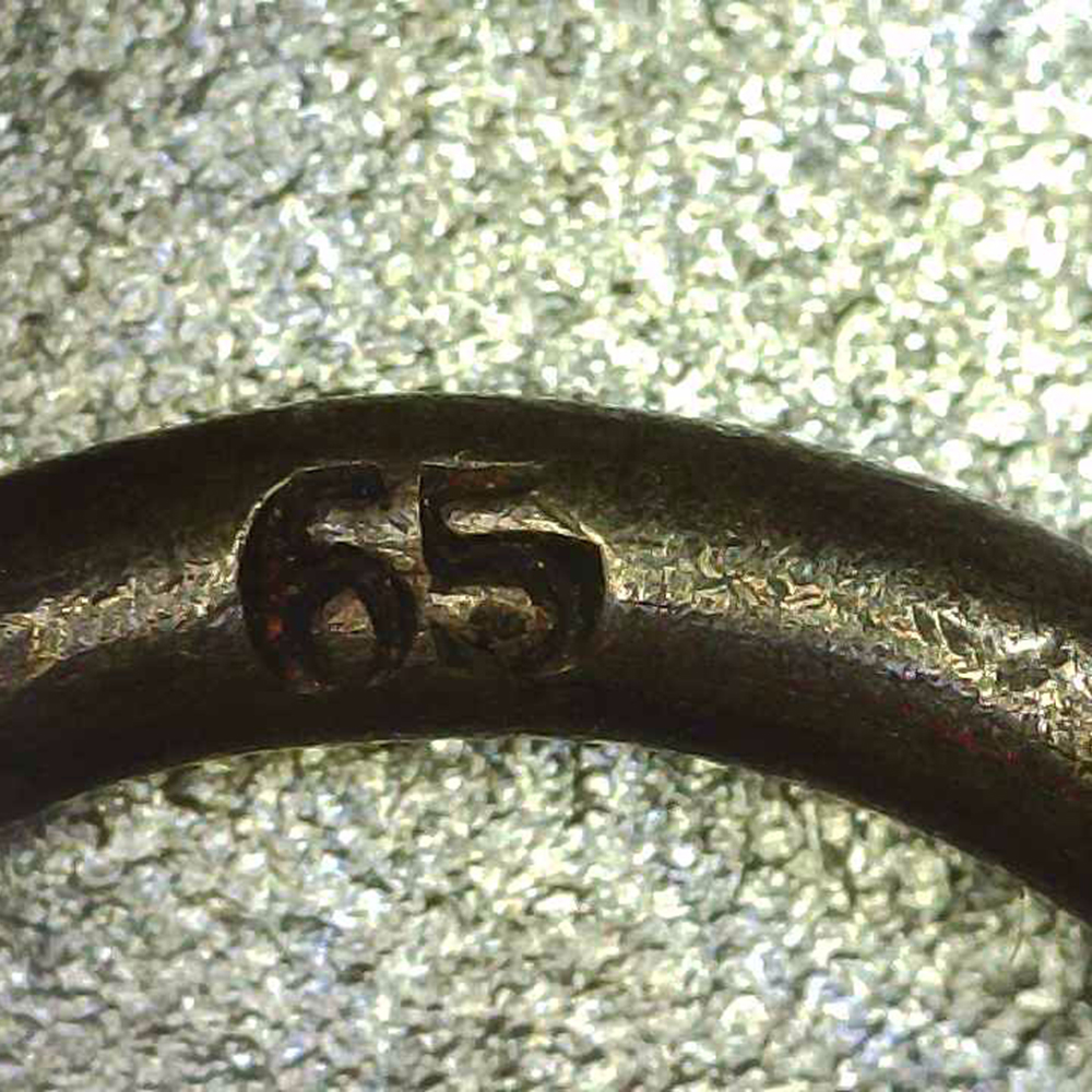 Detailed close‑up of the suspension ring showing the maker mark ‘65’ stamped inside, identifying Klein & Quenzer as the manufacturer.