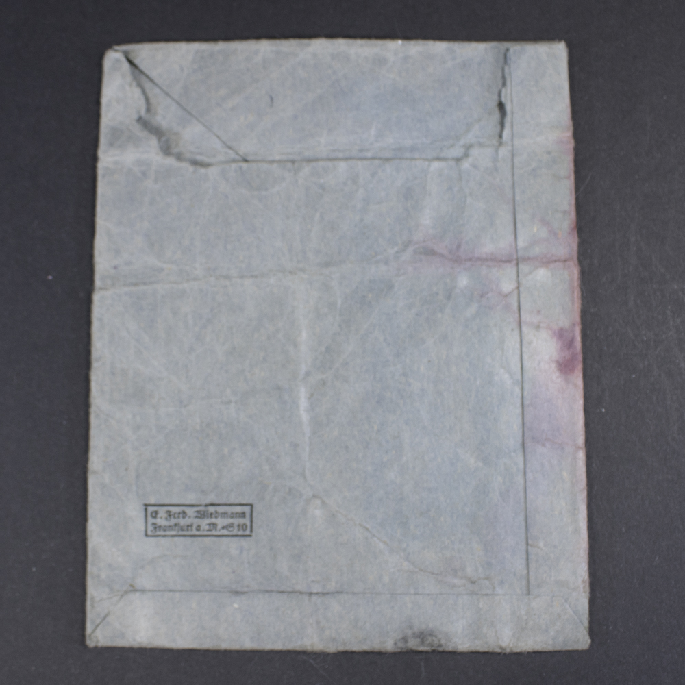 Rear view of the dark blue medal bag, showing the texture and stitching of the material without additional markings.