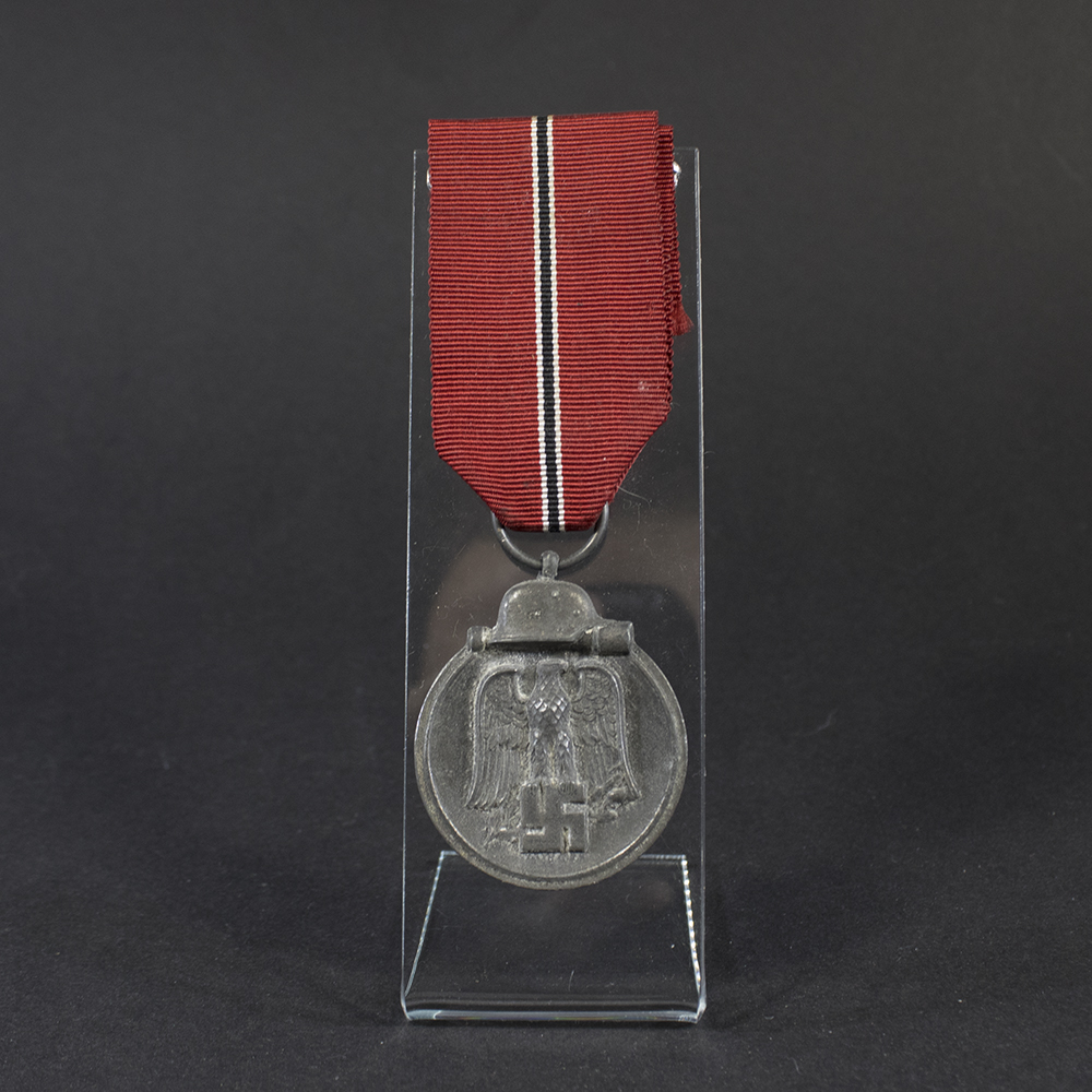 Full view of a World War II German Eastern Front Medal, showing the complete medal with its red‑white‑black ribbon attached.