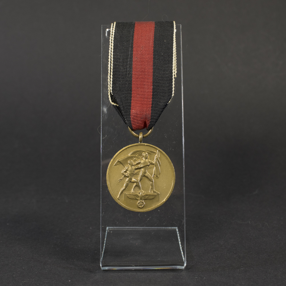 Full view of a World War II German Sudetenland Occupation Medal with its red‑white‑black striped ribbon, showing the complete medal and suspension.