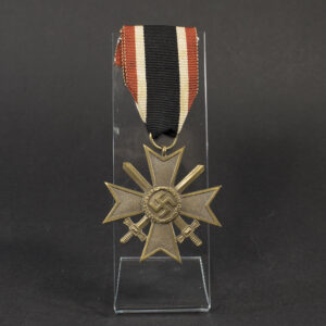 Full view of a World War II German War Merit Cross 2nd Class with Swords, showing the bronze‑colored medal and attached ribbon with red, white, and black stripes