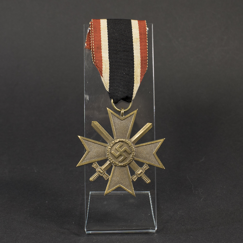 Full view of a World War II German War Merit Cross 2nd Class with Swords, showing the bronze‑colored medal and attached ribbon with red, white, and black stripes